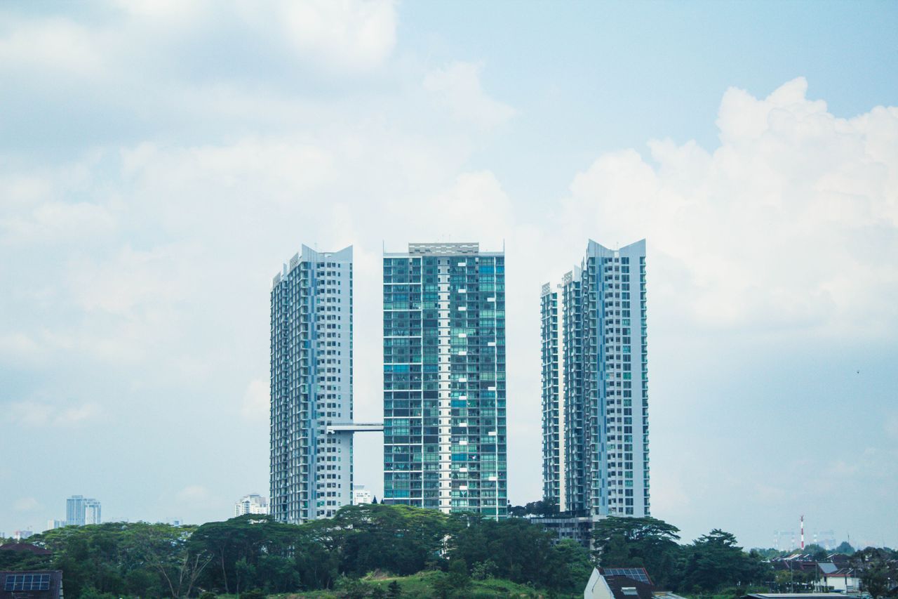 Contemporary architectural high-rises under a bright sky in Johor Bahru, Malaysia.